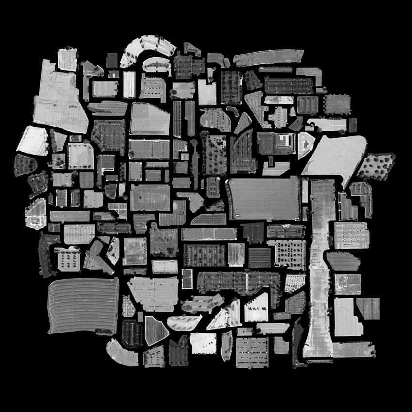 A collection of black-and-white cutouts of satellite imagery of empty parking lots, some small and some very large, against a black backdrop