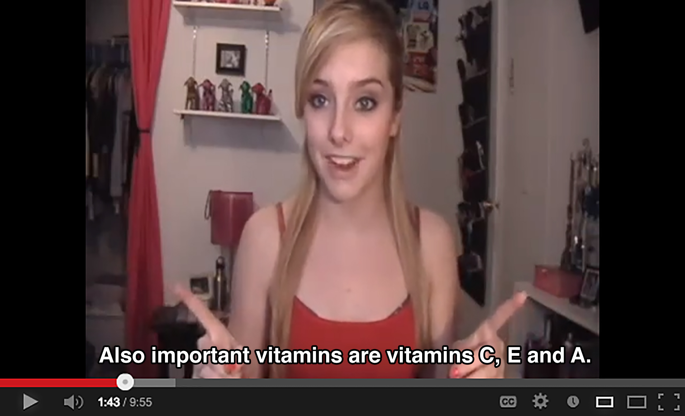 A teenager in a bedroom gestures with both index fingers and says: Also important vitamins are vitamins C, E, and A.