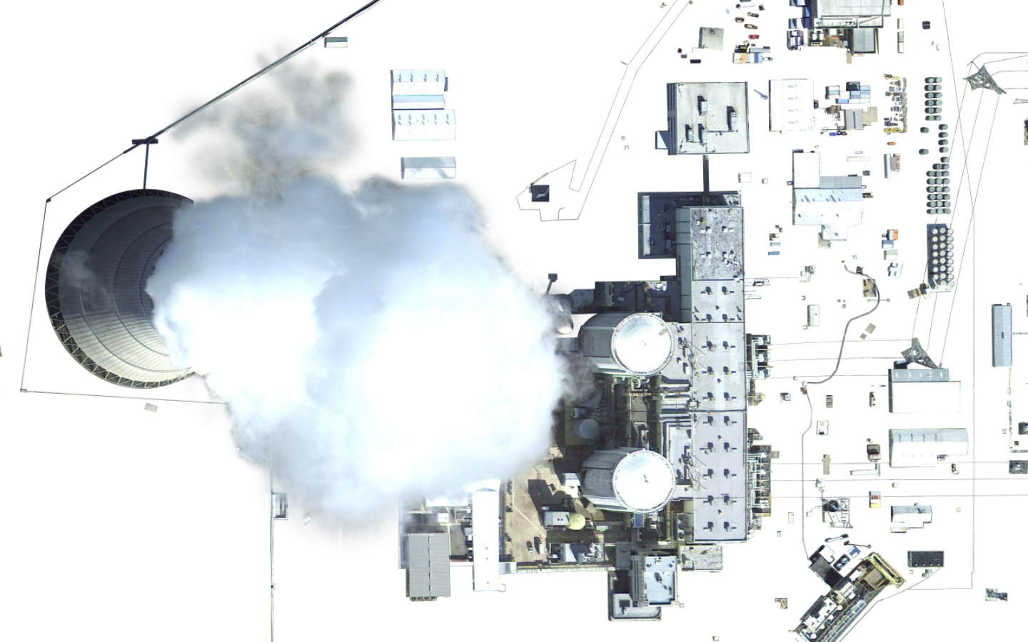 Isolated satellite imagery of a nuclear power plant, showing buildings and steam coming out of a large tower