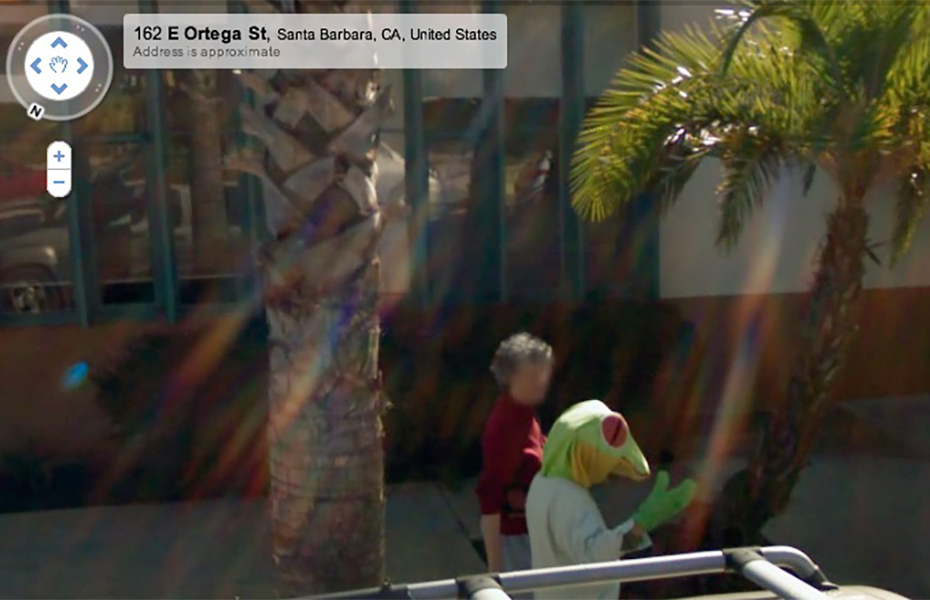 Screenshot of Street View in Santa Barbara showing a person casually walking and chatting with someone in a lizard costume